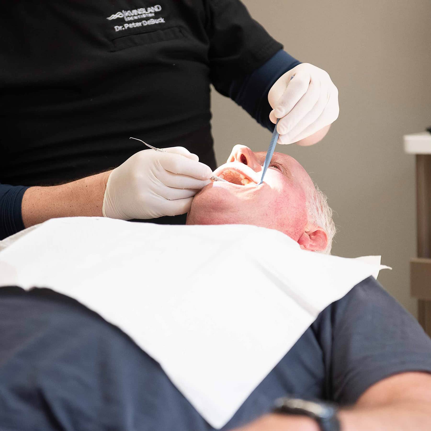 A man getting checked his tooth checked after receiving a composite filling.