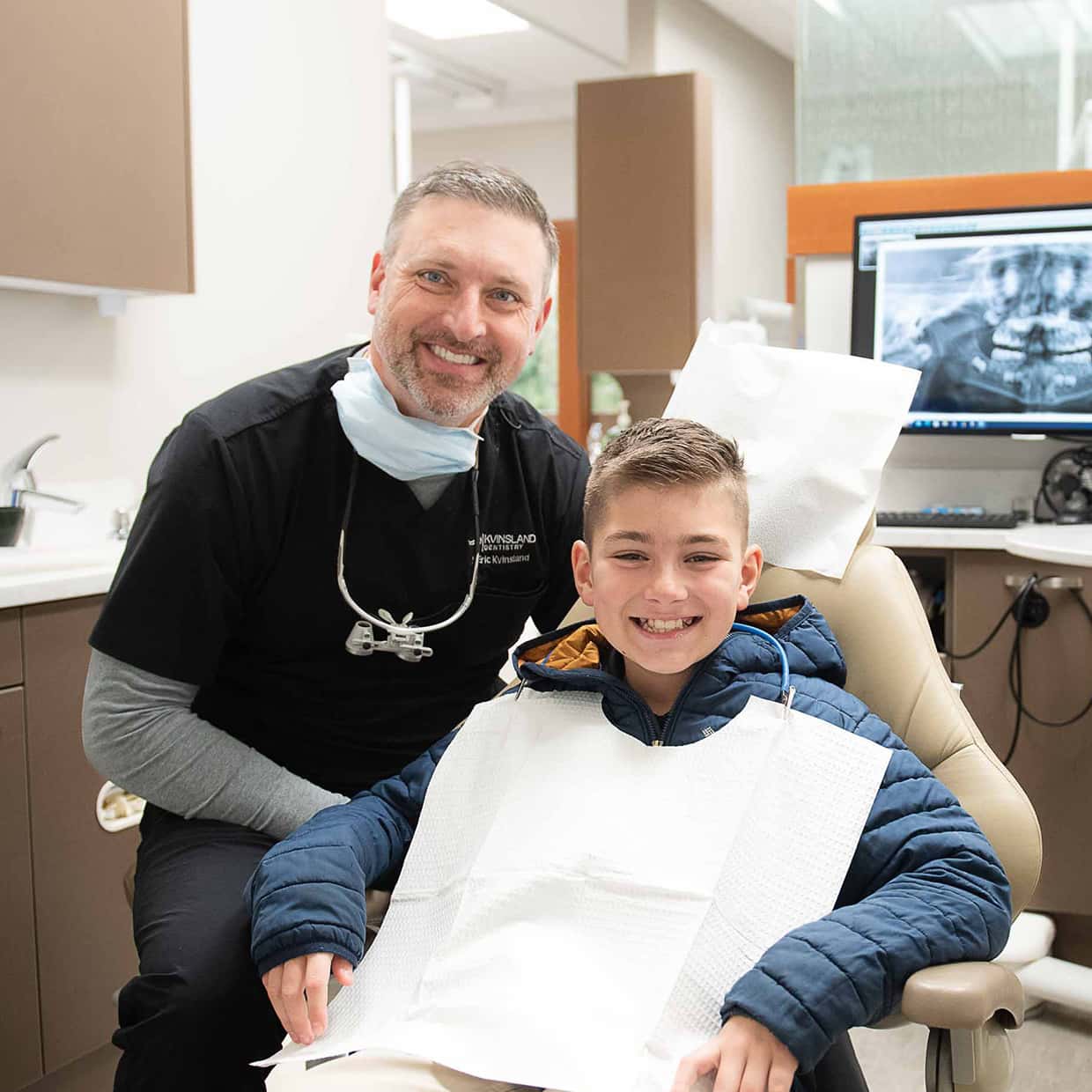 A happy child with the dentist after a visit. Fun dental for kids helps make the difference.
