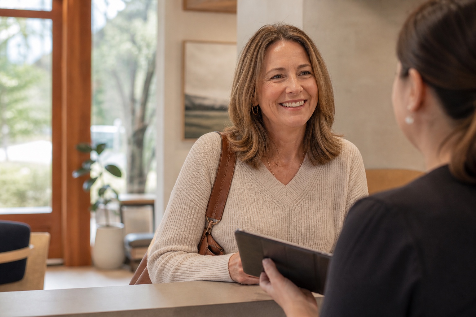 A patient receiving help with visit information in a welcoming dental office